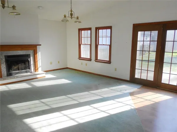 a view of an empty room with windows