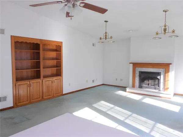 a view of an empty room with a fireplace