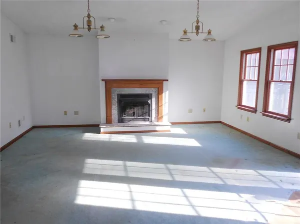 a view of empty room with fireplace