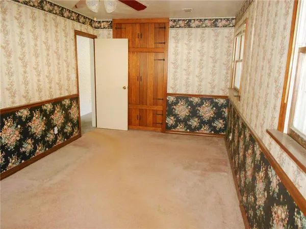 a view of a porch with window and curtain