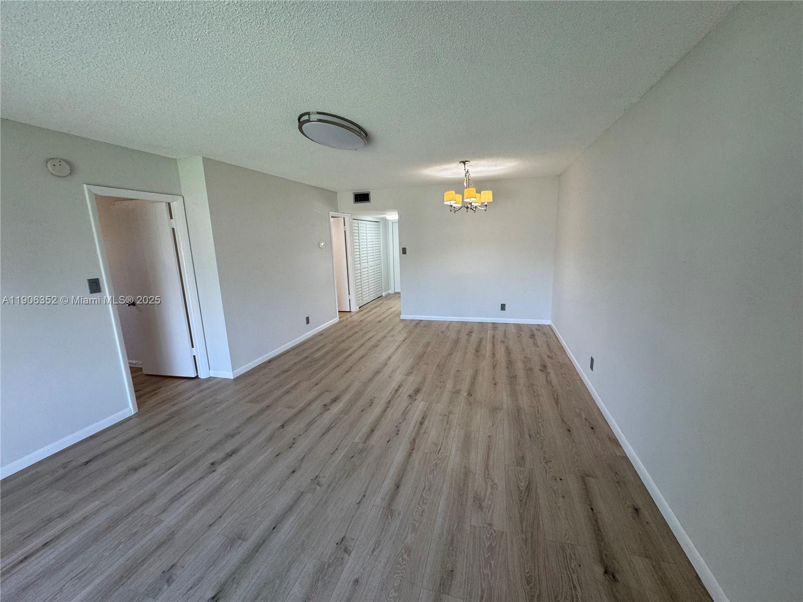7205 Northwest 5th Court, Unit 202 Margate, FL 33063 - Photo 5 of 15 wooden floor in an empty room with a window