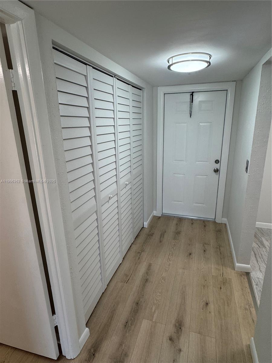7205 Northwest 5th Court, Unit 202 Margate, FL 33063 - Photo 6 of 15 wooden floor in an empty room with a window