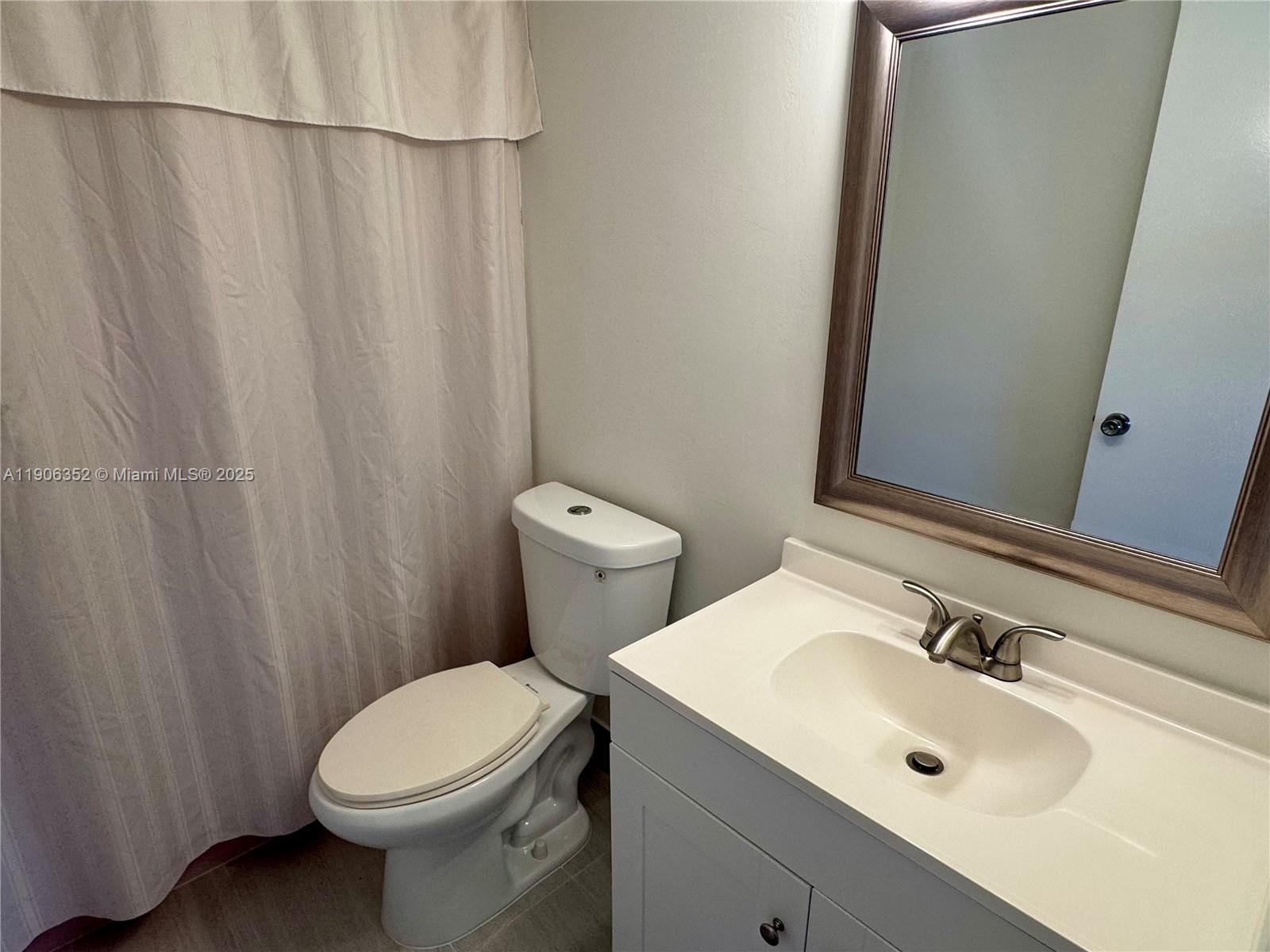 7205 Northwest 5th Court, Unit 202 Margate, FL 33063 - Photo 8 of 15 a bathroom with a sink a toilet and shower