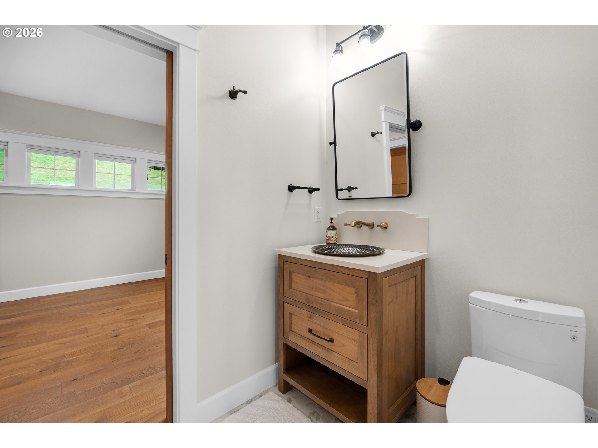 38590 Meadow Loop Nehalem, OR 97131 - Photo 36 of 48 a bathroom with a sink vanity granite toilet and a mirror