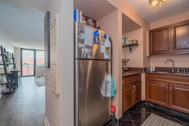 a kitchen with stainless steel appliances granite countertop a refrigerator and a sink