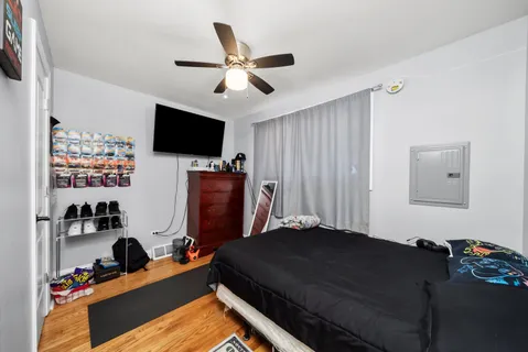 a bedroom with a bed and a flat screen tv