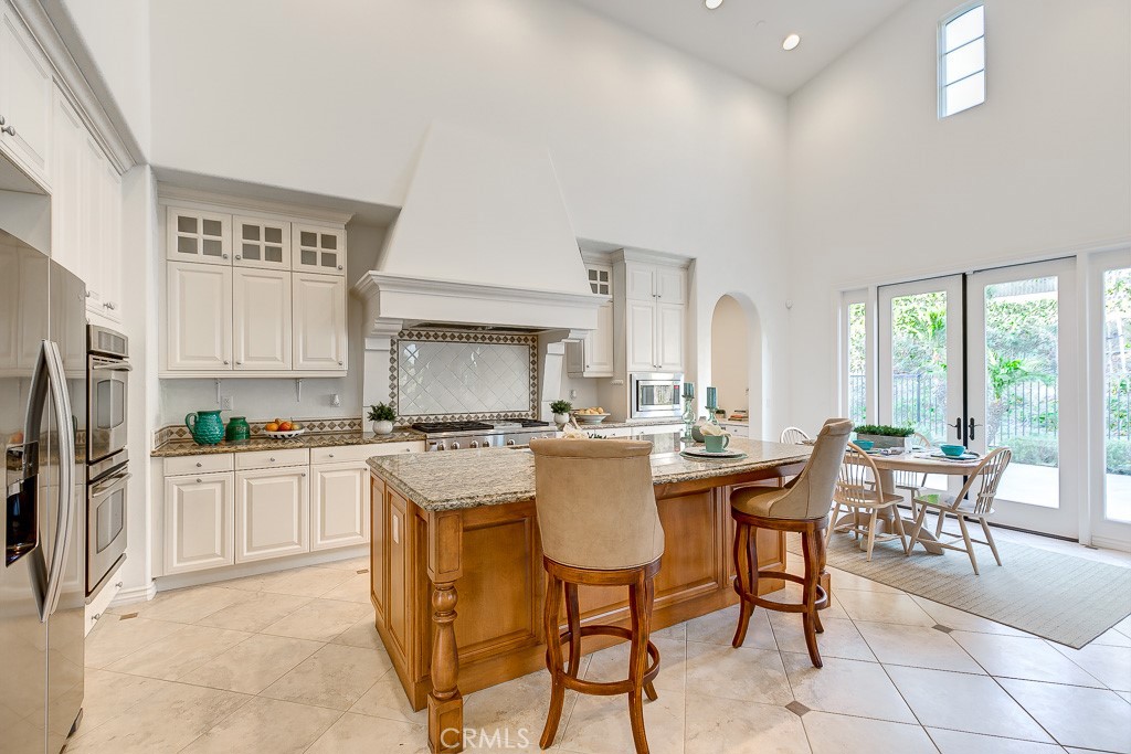 501 Luminous Irvine, CA 92603 - Photo 16 of 53 a kitchen with a table chairs stove and white cabinets