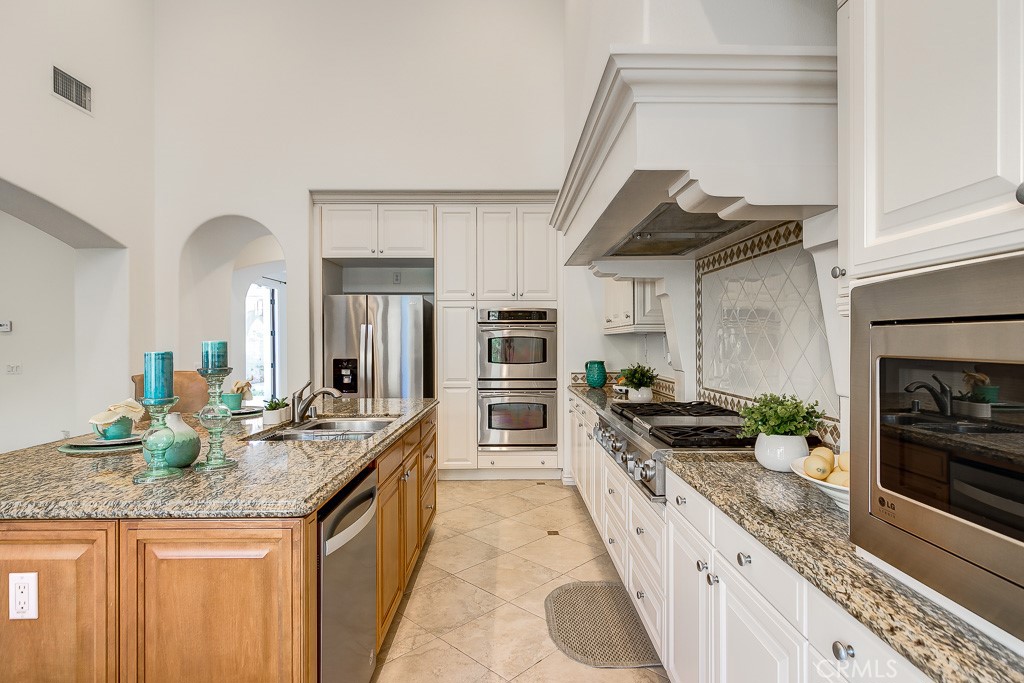 501 Luminous Irvine, CA 92603 - Photo 24 of 53 a kitchen with granite countertop stainless steel appliances and wooden cabinets
