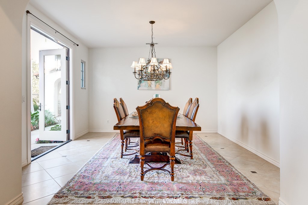 501 Luminous Irvine, CA 92603 - Photo 27 of 53 a dining room with furniture a rug and a chandelier