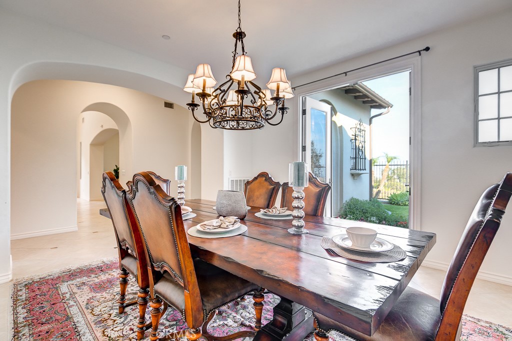 501 Luminous Irvine, CA 92603 - Photo 28 of 53 a view of a dining room with furniture a chandelier and wooden floor