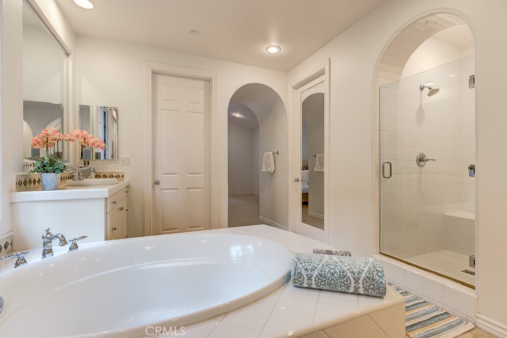 501 Luminous Irvine, CA 92603 - Photo 35 of 53 a bathroom with a tub sink and mirror
