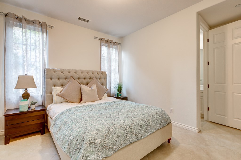 501 Luminous Irvine, CA 92603 - Photo 36 of 53 a bedroom with a bed and window