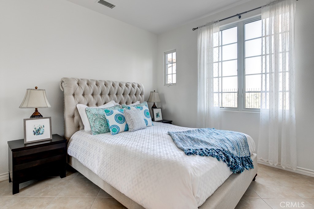 501 Luminous Irvine, CA 92603 - Photo 38 of 53 a bedroom with a bed and window