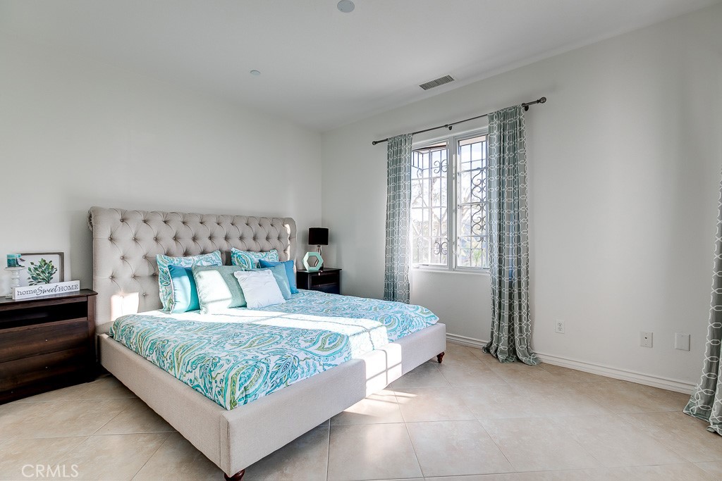 501 Luminous Irvine, CA 92603 - Photo 40 of 53 a bedroom with a large bed and a window