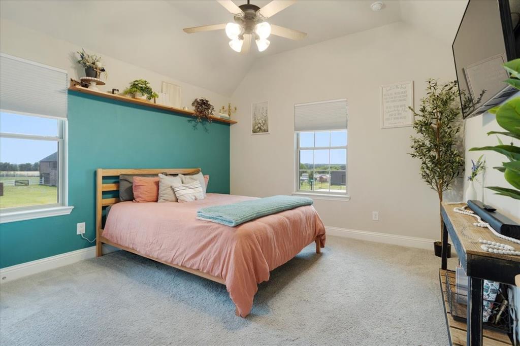 1205 Redbud Street Howe, TX 75459 - Photo 22 of 40 a bedroom with a bed and a chandelier