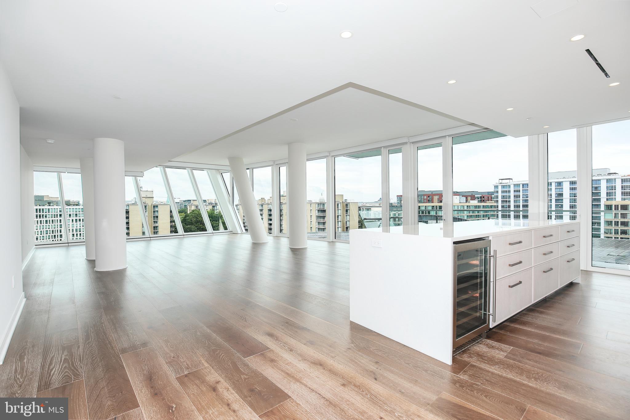601 Wharf Street Southwest, Unit 905 Washington, DC 20024 - Photo 4 of 28 a hallway with hardwood floor and a kitchen view