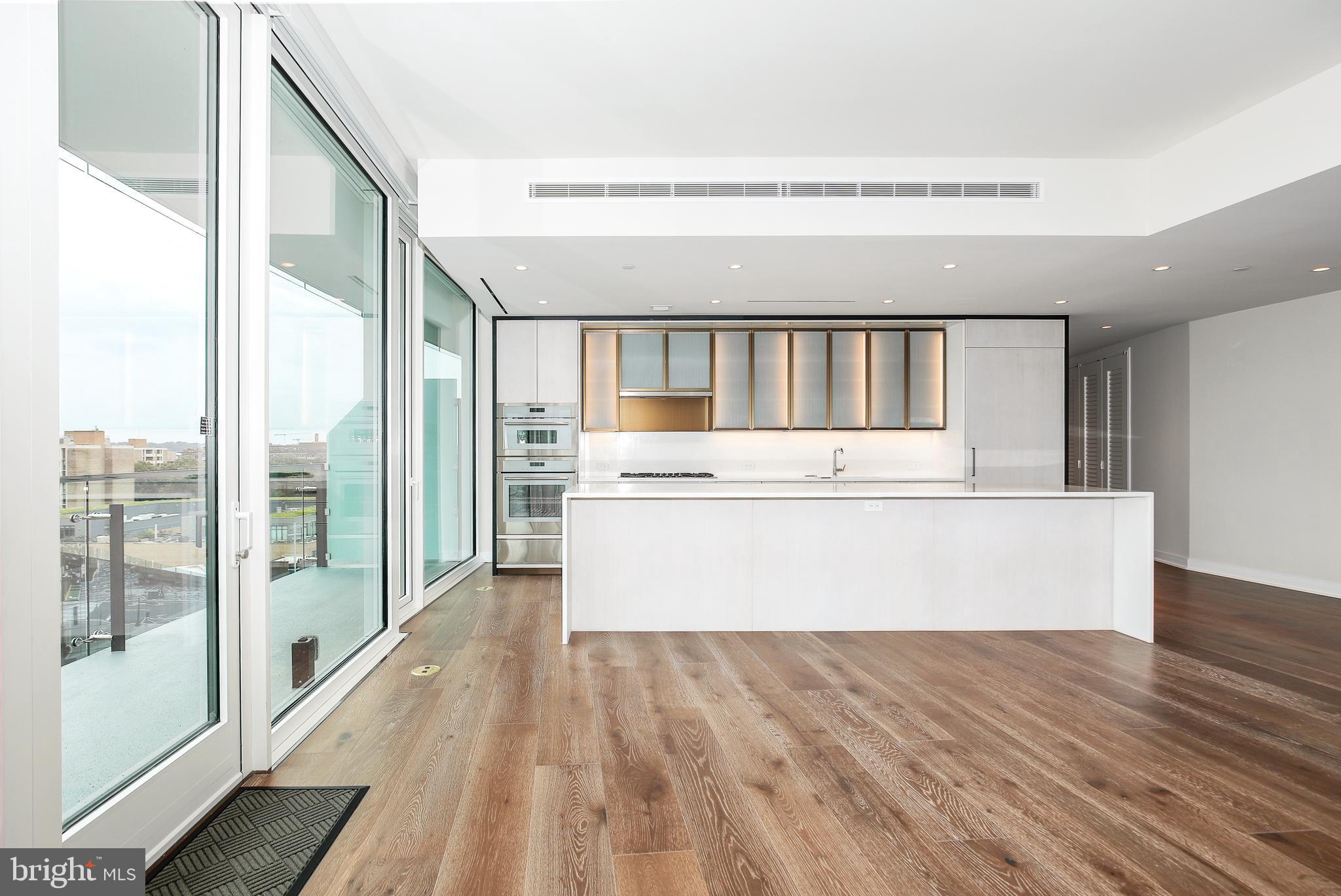 601 Wharf Street Southwest, Unit 905 Washington, DC 20024 - Photo 6 of 28 a view of wooden floor and a large window