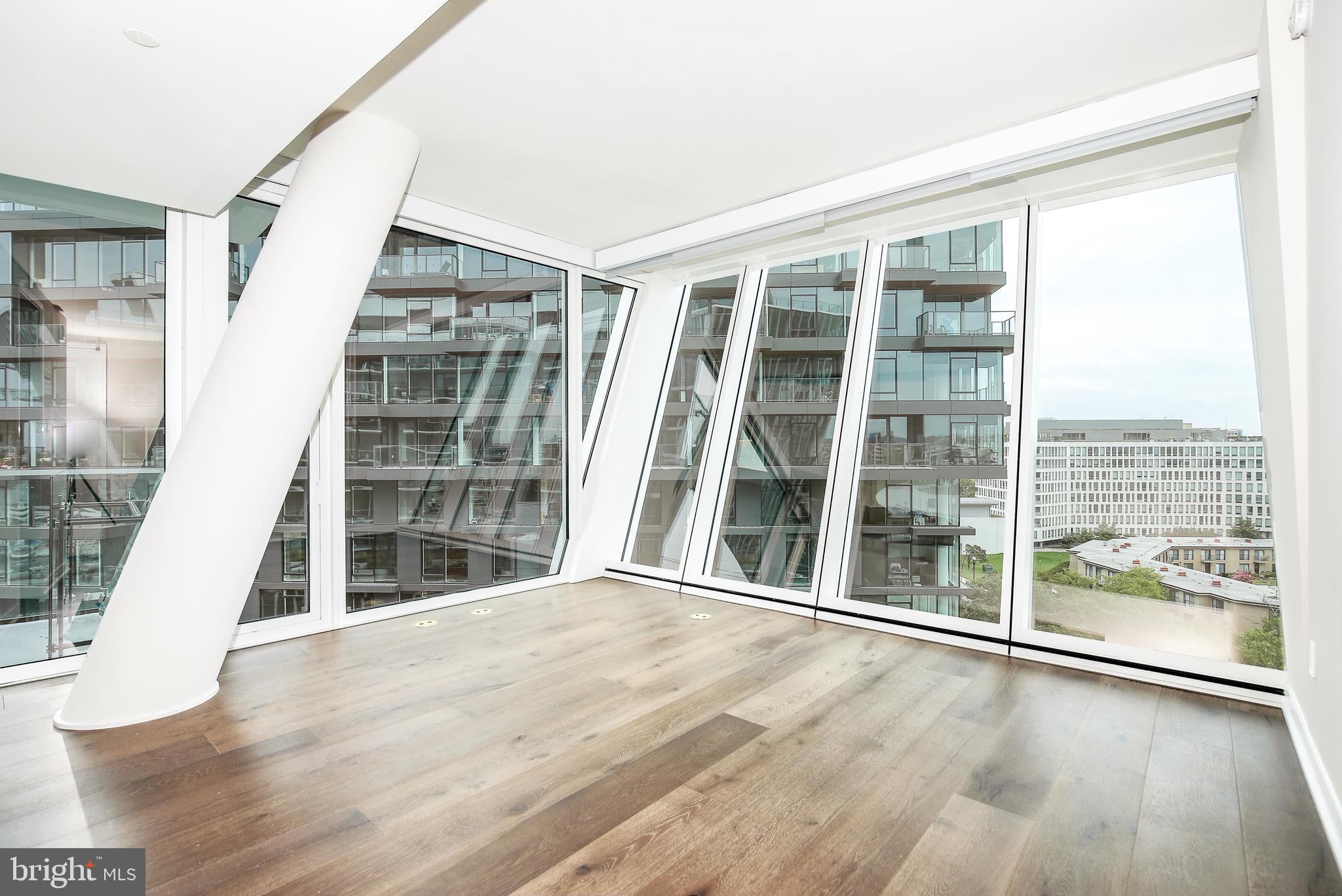 601 Wharf Street Southwest, Unit 905 Washington, DC 20024 - Photo 9 of 28 a view of an empty room with wooden floor and windows