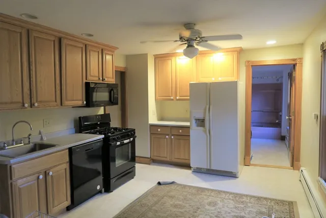 a kitchen with a refrigerator and a sink