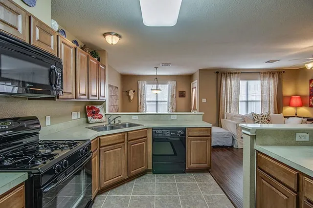 a kitchen with a stove top oven sink and cabinets