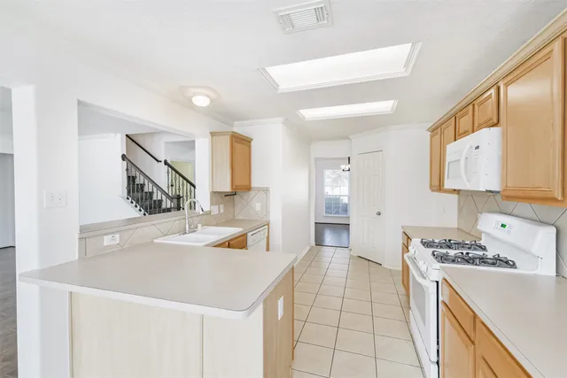 a kitchen with a stove a sink dishwasher and a refrigerator