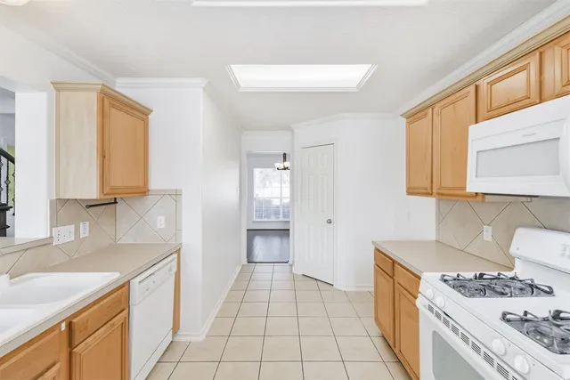 a kitchen with a sink a stove and cabinets