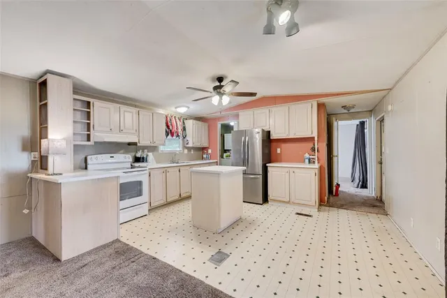 a kitchen with white cabinets and white appliances