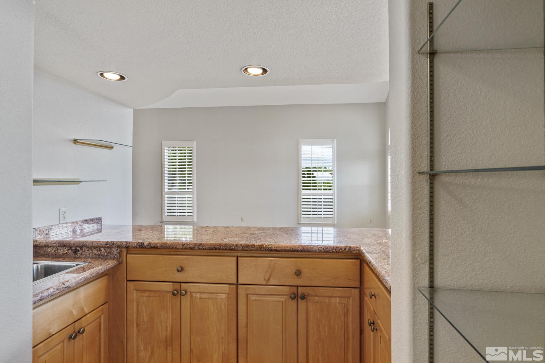 6172 Squires Lane Reno, NV 89519 - Photo 14 of 40 a kitchen with granite countertop cabinets stainless steel appliances and a window