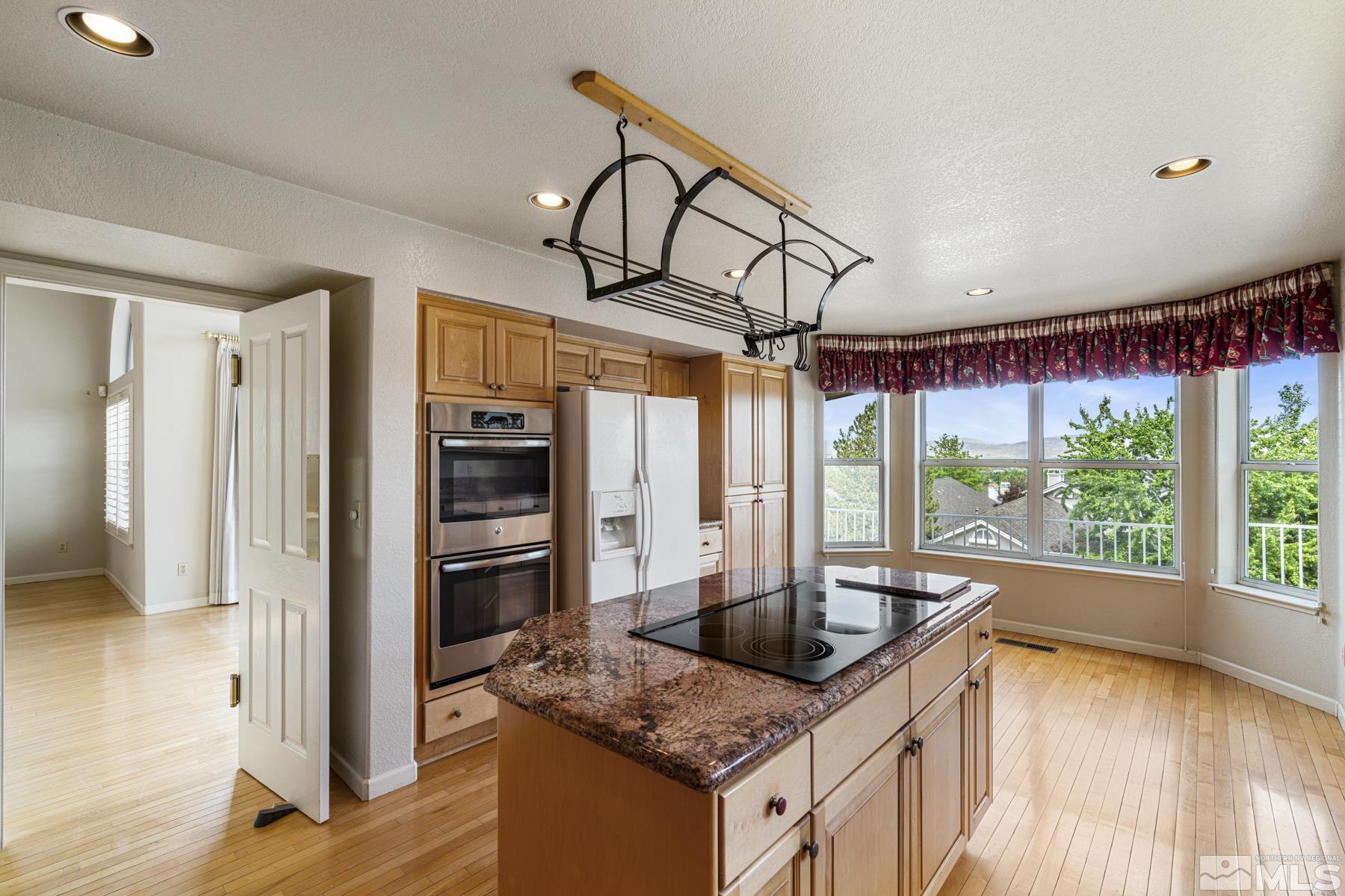 6172 Squires Lane Reno, NV 89519 - Photo 15 of 40 a kitchen that has a sink a counter top space and stainless steel appliances