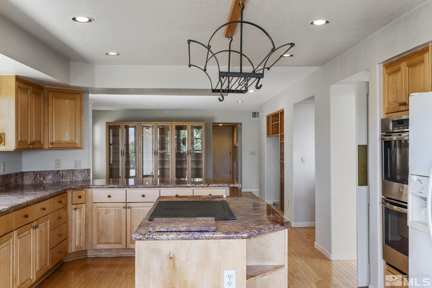6172 Squires Lane Reno, NV 89519 - Photo 17 of 40 a kitchen with stainless steel appliances granite countertop a sink a stove cabinets counter space and a window