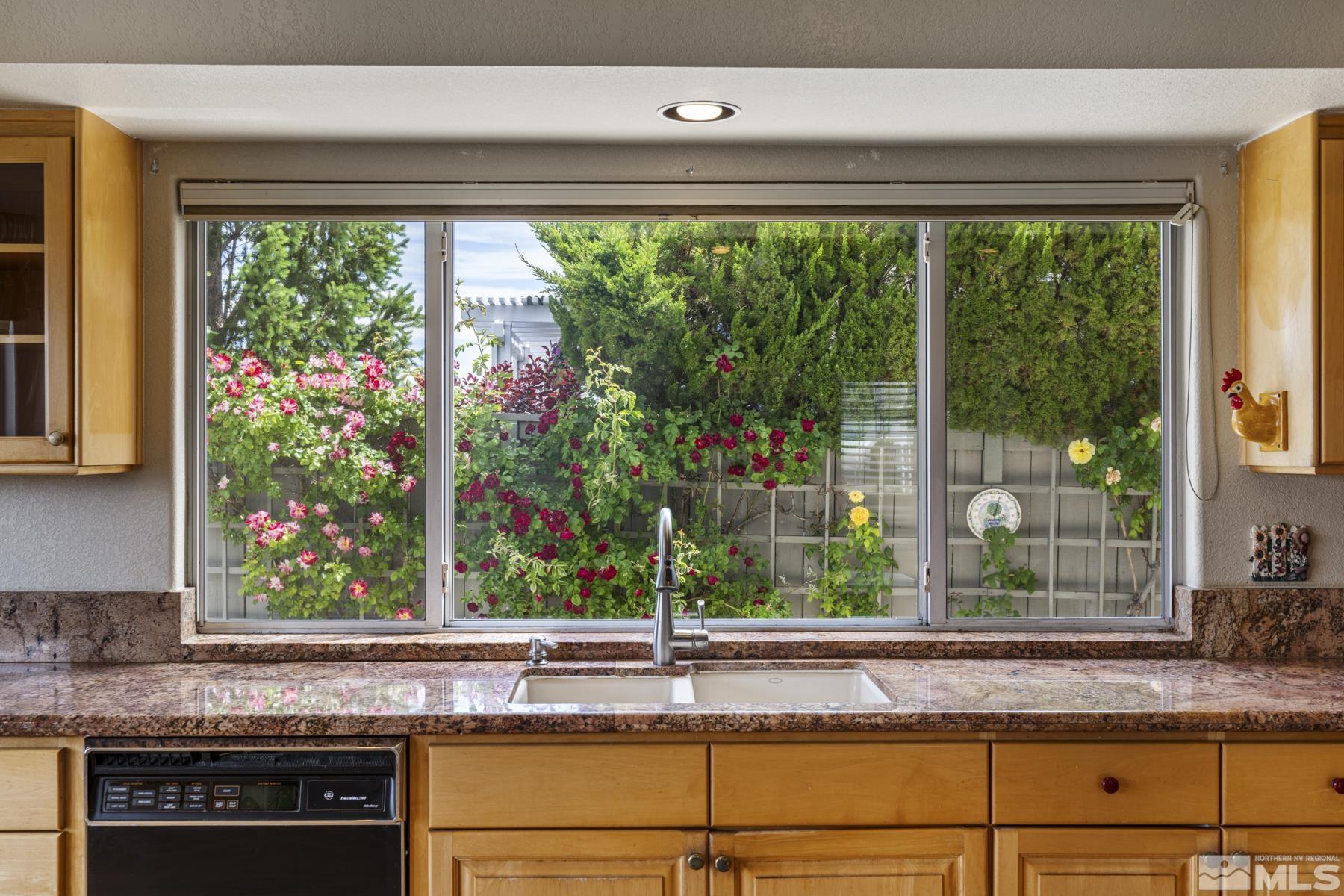 6172 Squires Lane Reno, NV 89519 - Photo 18 of 40 a kitchen sink sitting area with a floor to ceiling window and sink