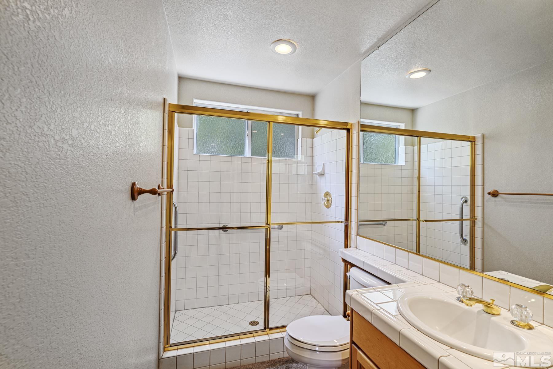 6172 Squires Lane Reno, NV 89519 - Photo 20 of 40 a bathroom with a sink toilet and shower