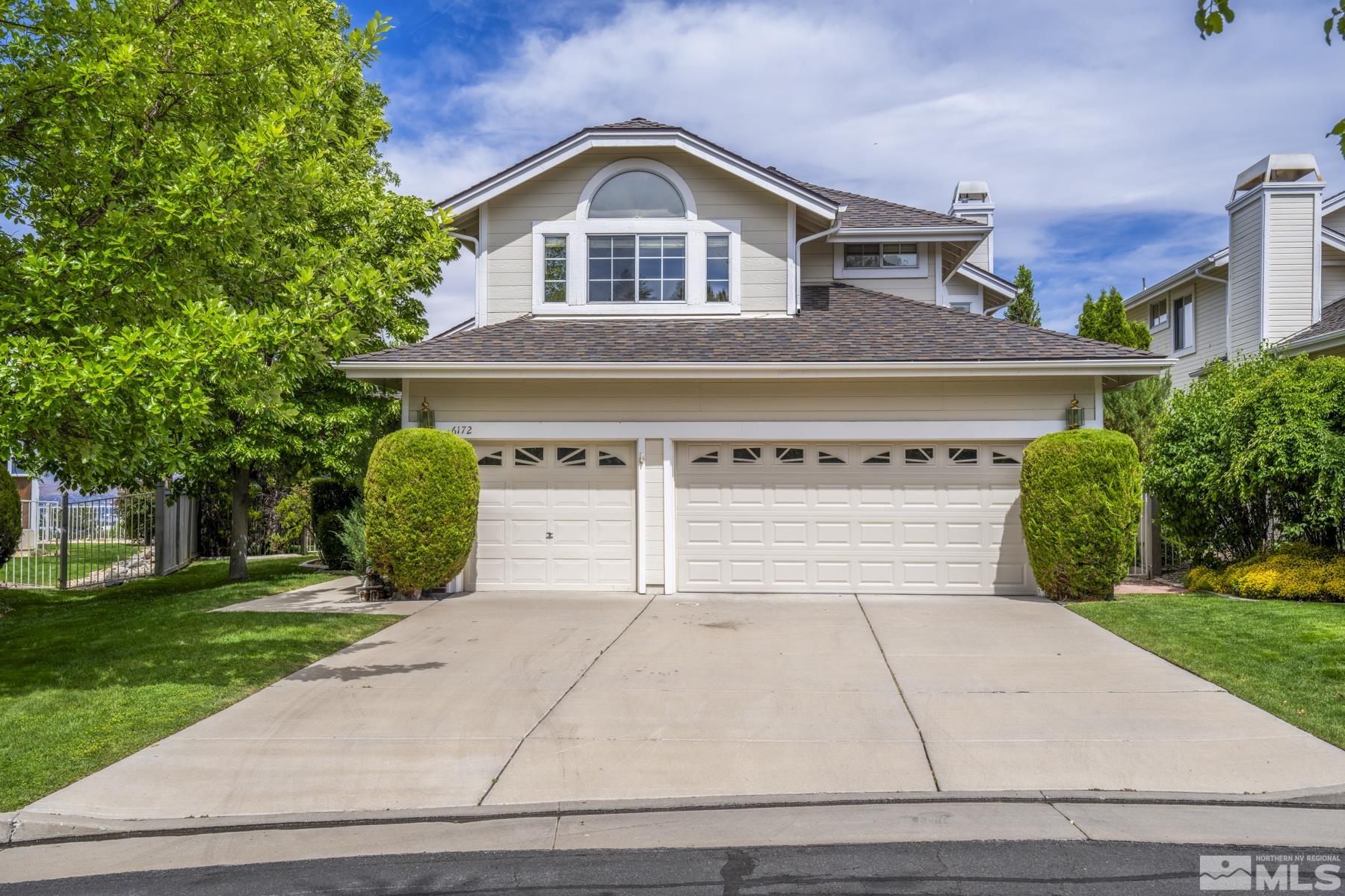 6172 Squires Lane Reno, NV 89519 - Photo 2 of 40 a front view of a house with a yard and garage