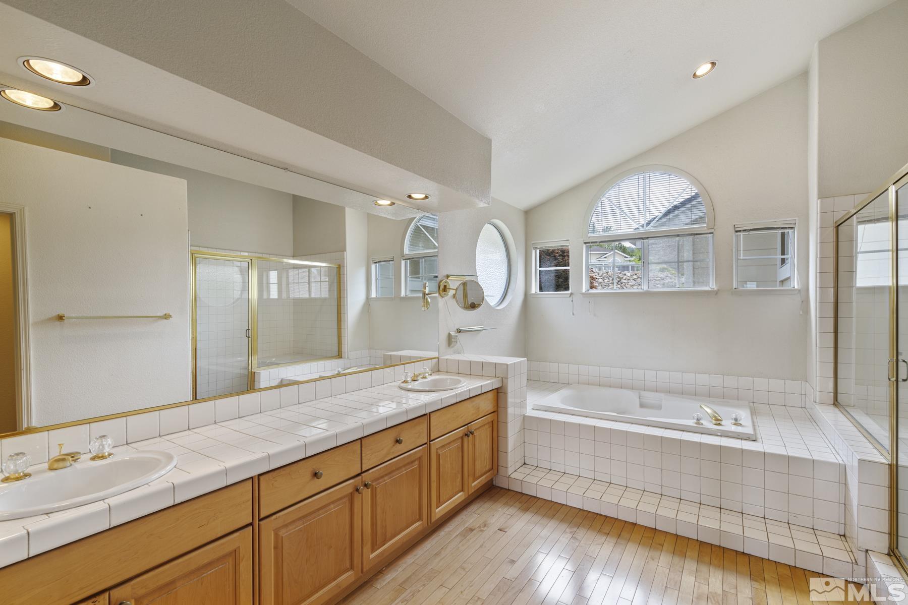 6172 Squires Lane Reno, NV 89519 - Photo 24 of 40 a spacious bathroom with a tub sink and mirror