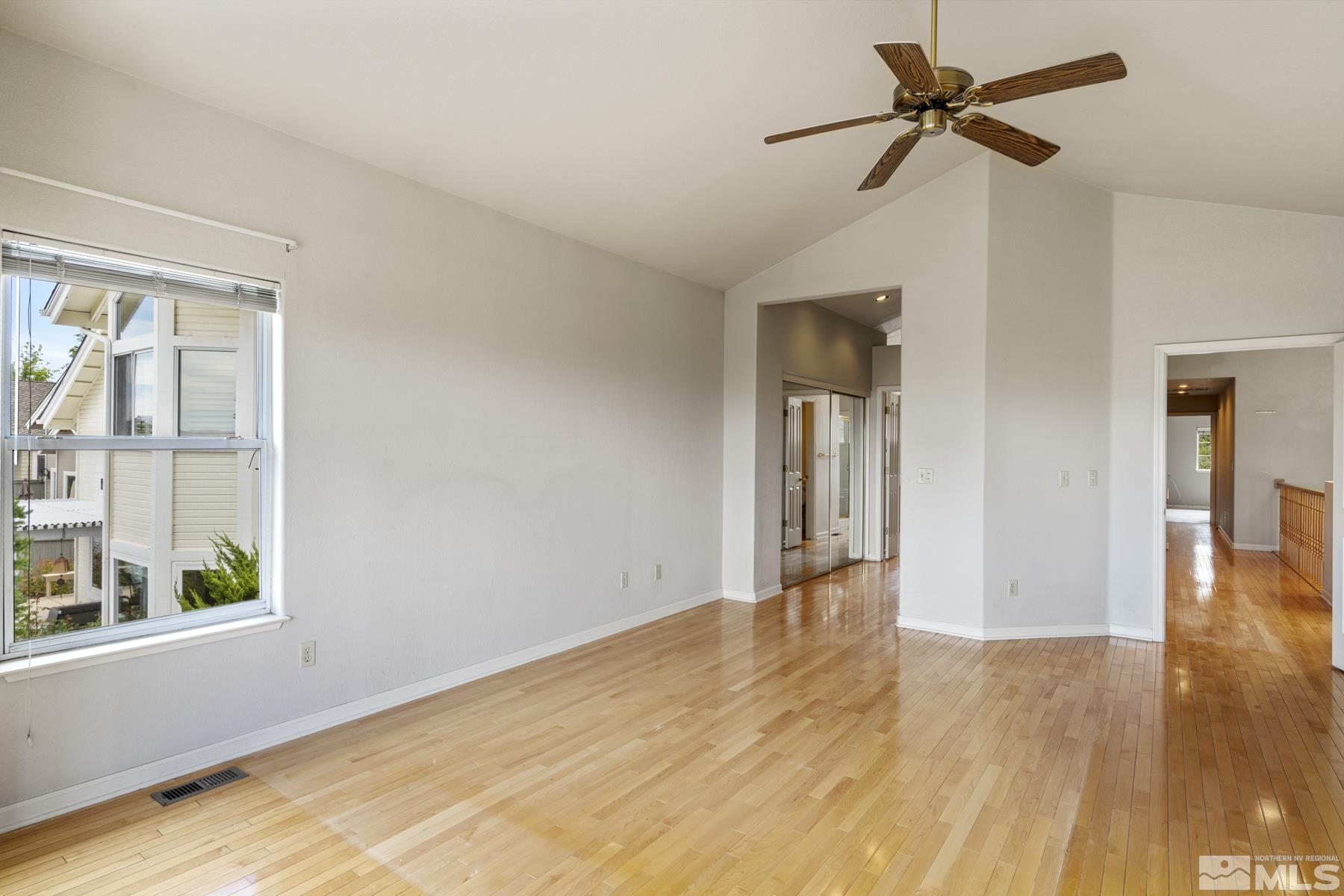6172 Squires Lane Reno, NV 89519 - Photo 25 of 40 a view of empty room with wooden floor and fan