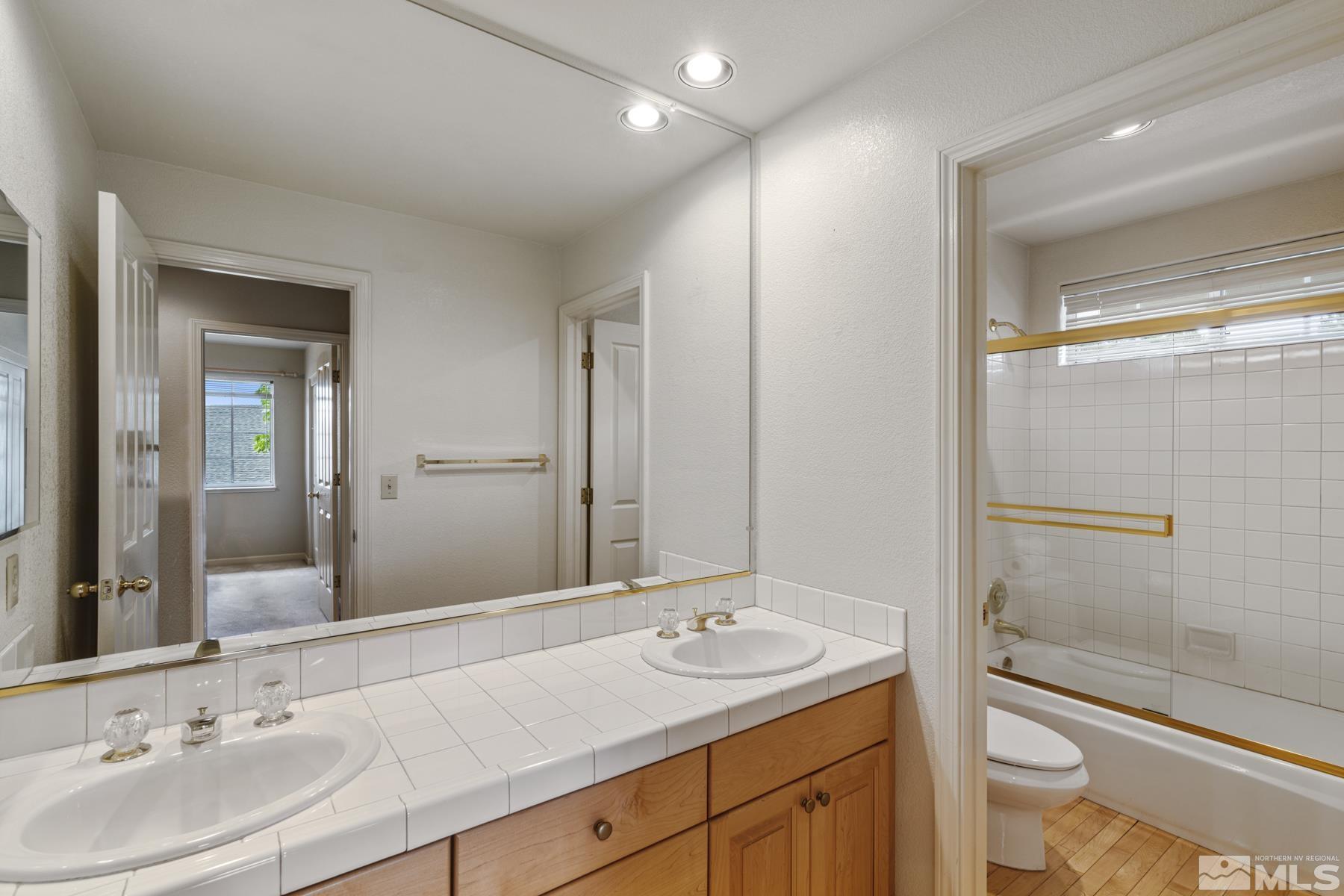 6172 Squires Lane Reno, NV 89519 - Photo 27 of 40 a bathroom with a sink and a mirror