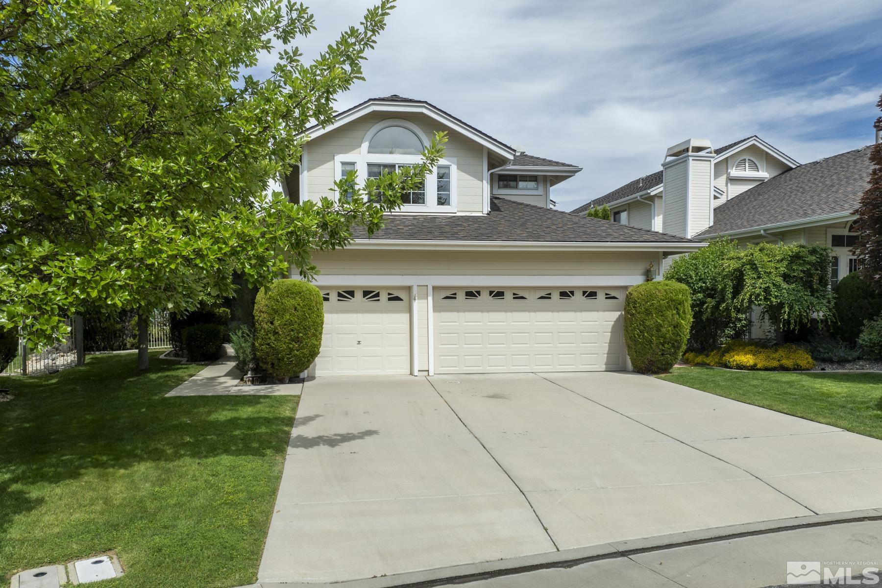 6172 Squires Lane Reno, NV 89519 - Photo 3 of 40 a front view of a house with a yard and garage