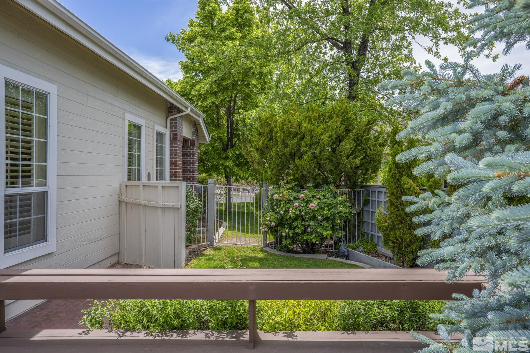 6172 Squires Lane Reno, NV 89519 - Photo 36 of 40 a front view of a house with a garden and plants