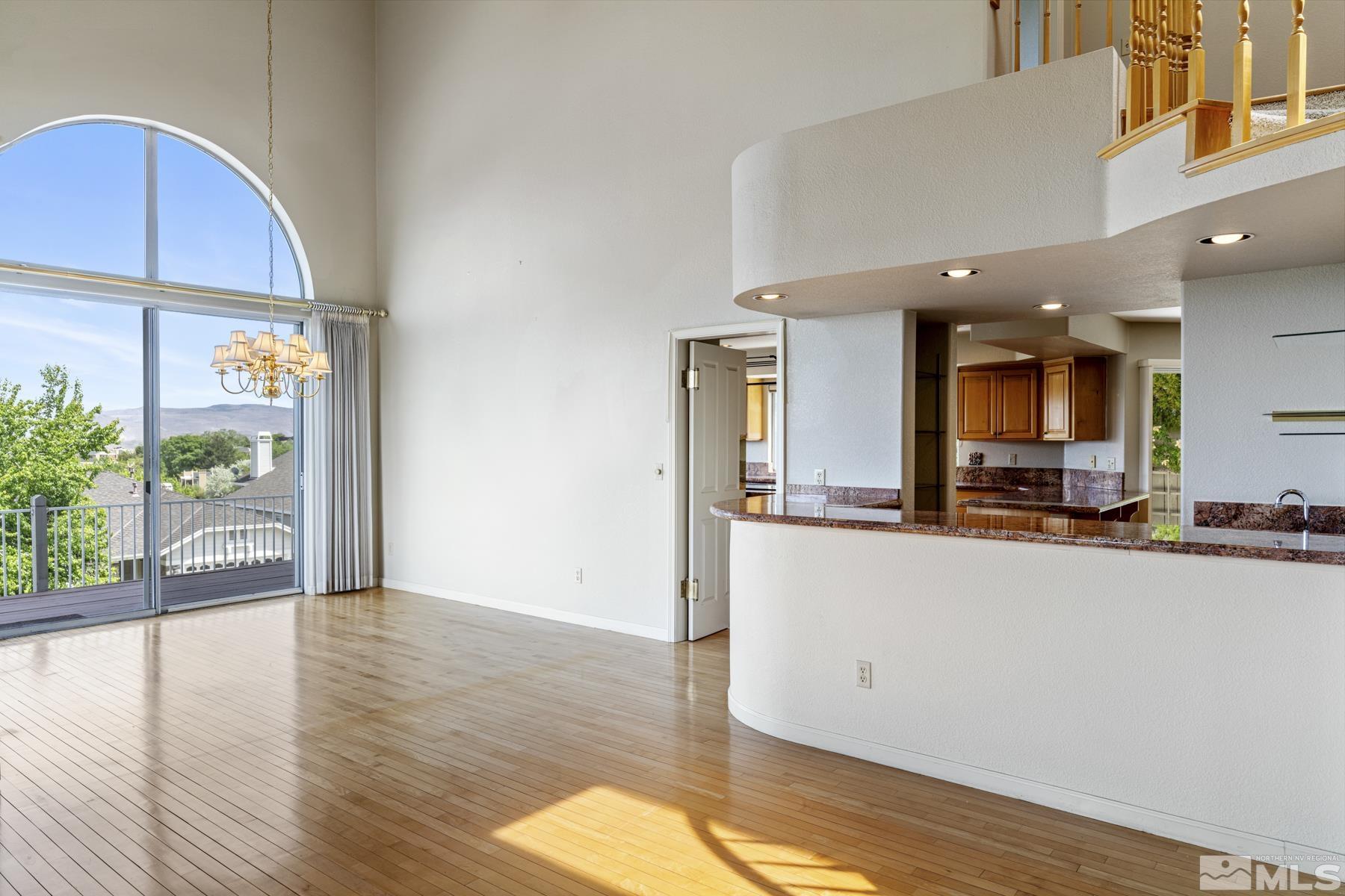 6172 Squires Lane Reno, NV 89519 - Photo 6 of 40 a view of a living room and kitchen with a large window