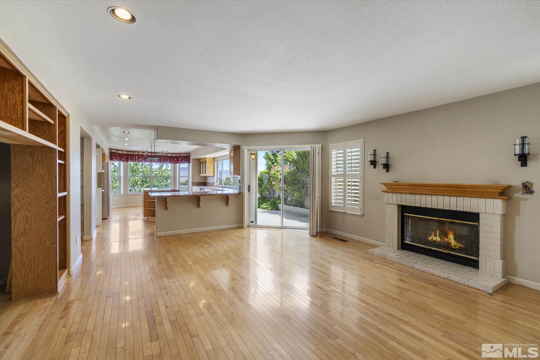 6172 Squires Lane Reno, NV 89519 - Photo 10 of 40 a view of a living room a fireplace with wooden floor and a fireplace