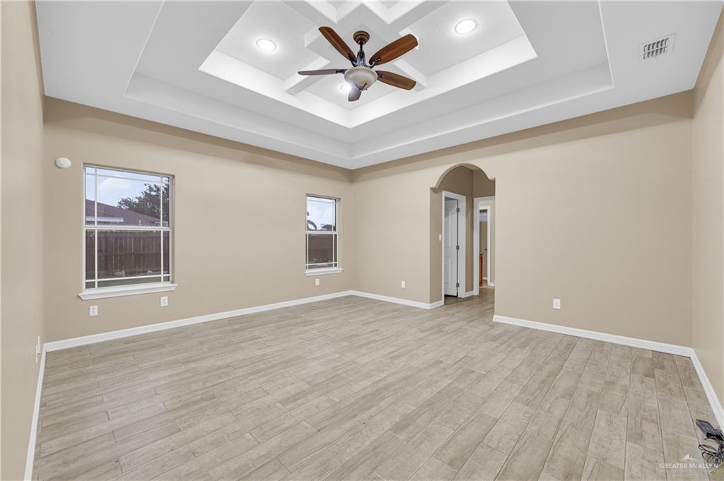 2005 Stuart Road Weslaco, TX 78599 - Photo 4 of 30 an empty room with windows and ceiling fan