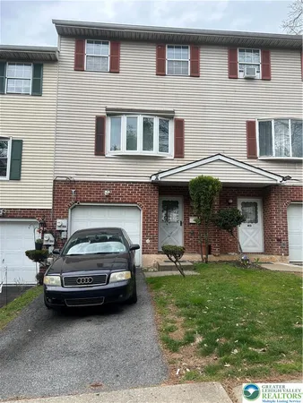 a car parked in front of a brick house