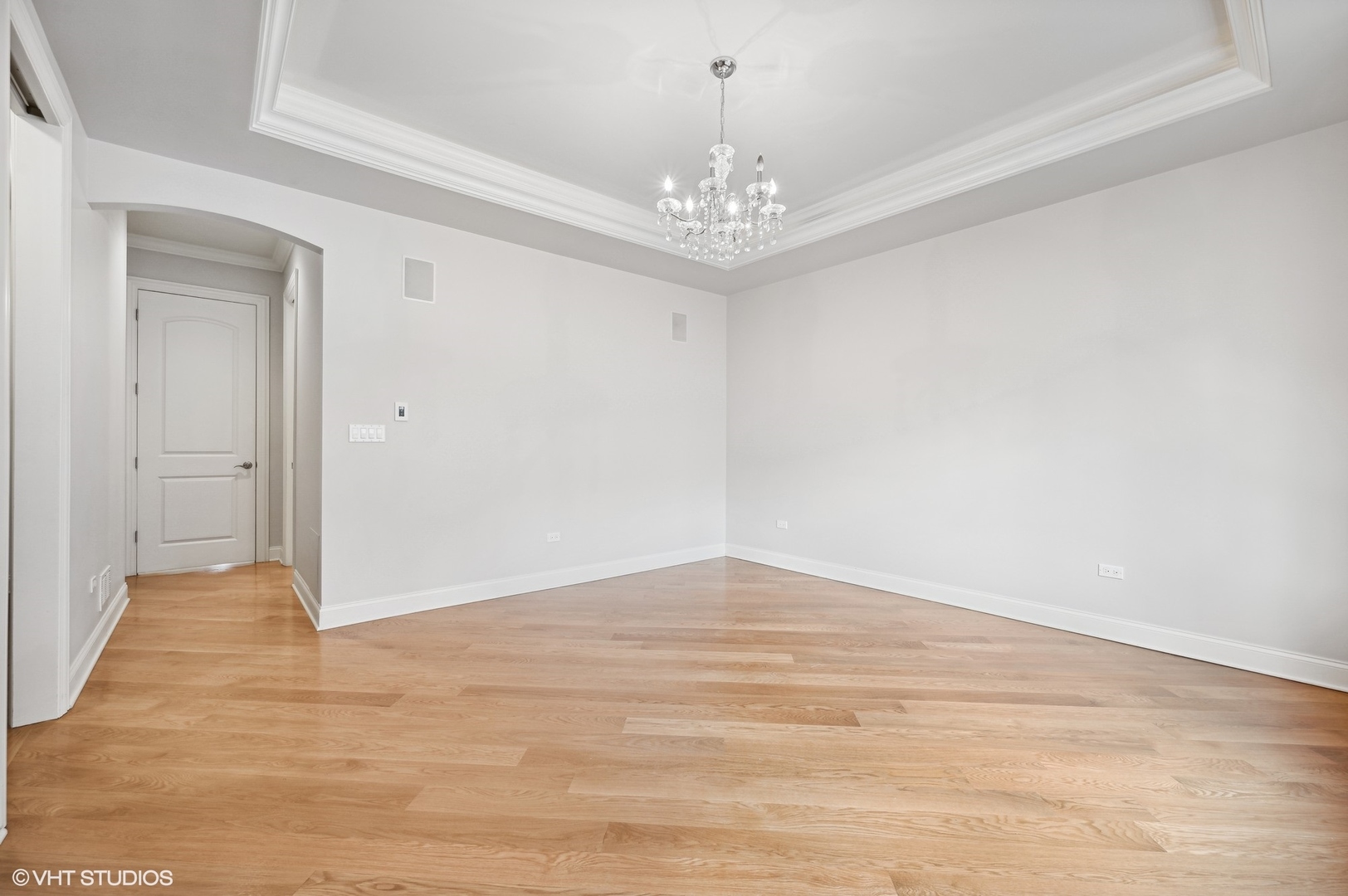 106 South Sangamon Street, Unit 3S Chicago, IL 60607 - Photo 11 of 20 a view of an empty room with wooden floor and a chandelier