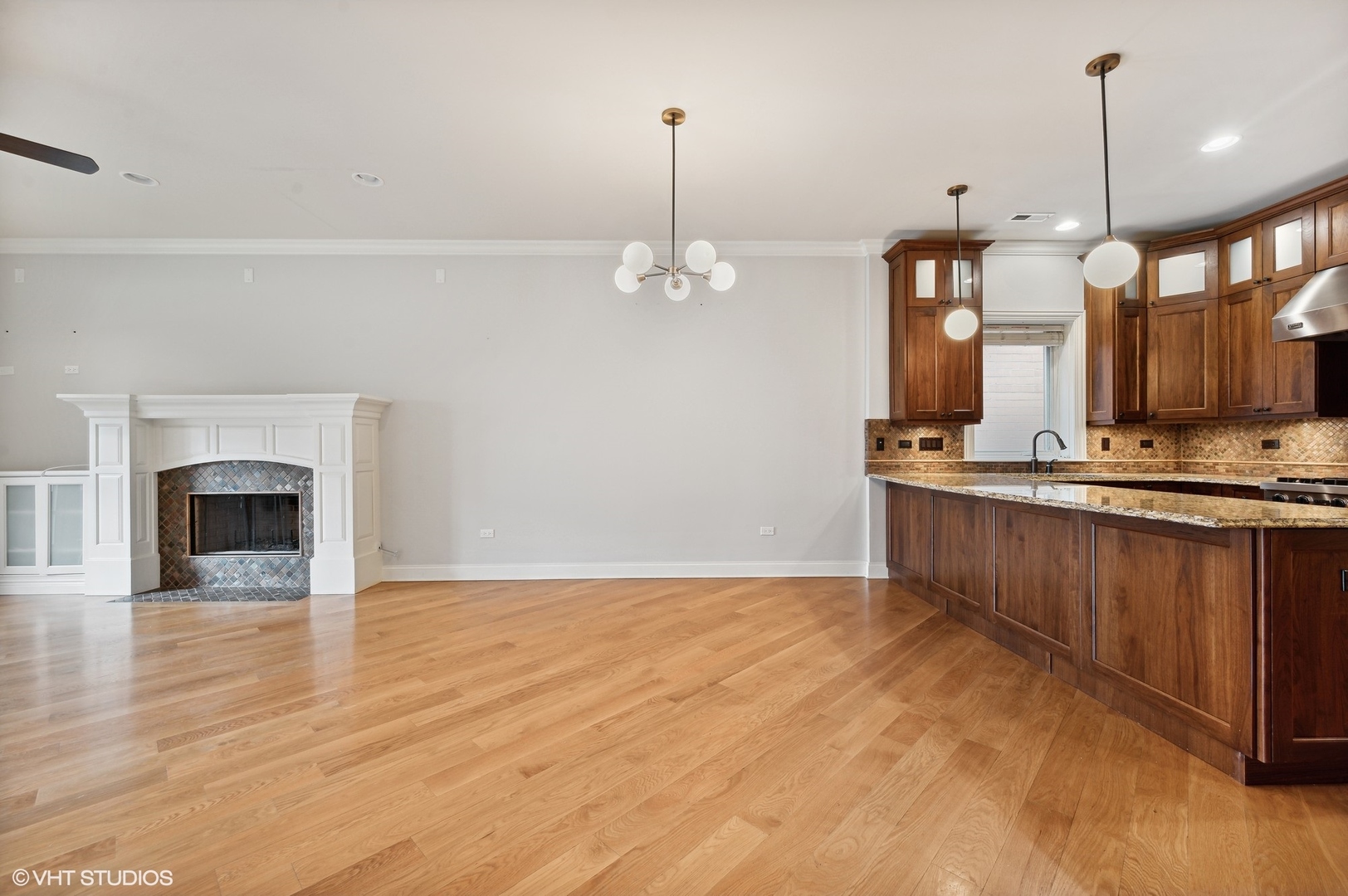 106 South Sangamon Street, Unit 3S Chicago, IL 60607 - Photo 3 of 20 a view of a kitchen with a sink and a fireplace