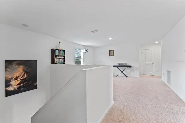 a living room with furniture and a painting on the wall