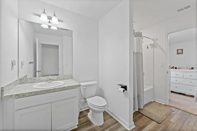 a bathroom with a toilet a sink and a mirror