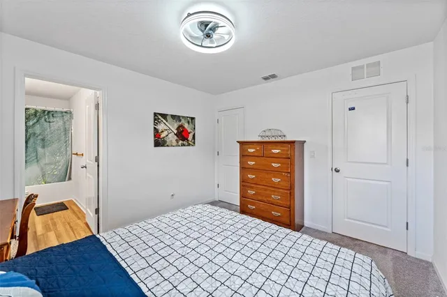 a bedroom with a bed and a dresser