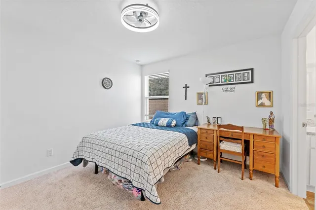 a bedroom with a bed and a table in it