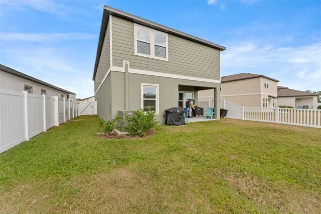 a house view with swimming pool in front of it