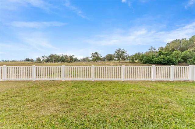a view of a green field near an ocean